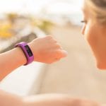 Woman looking at wearable fitness device